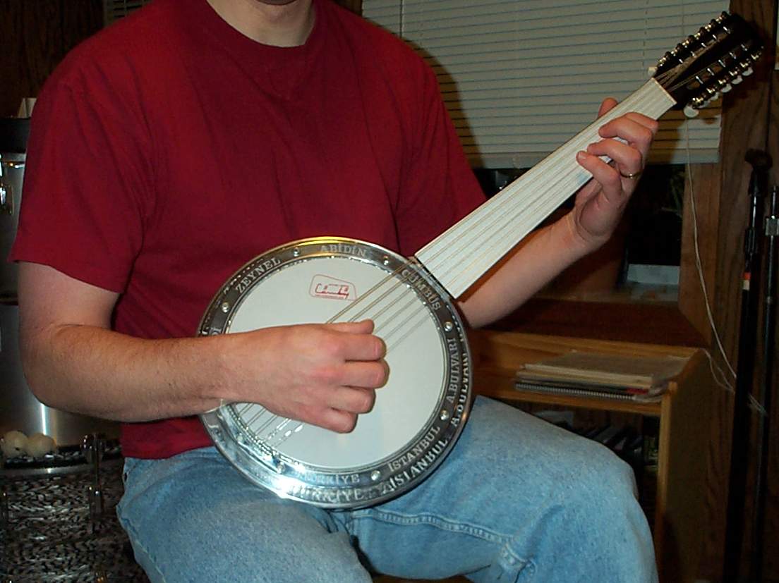 A cümbüş being held in playing position